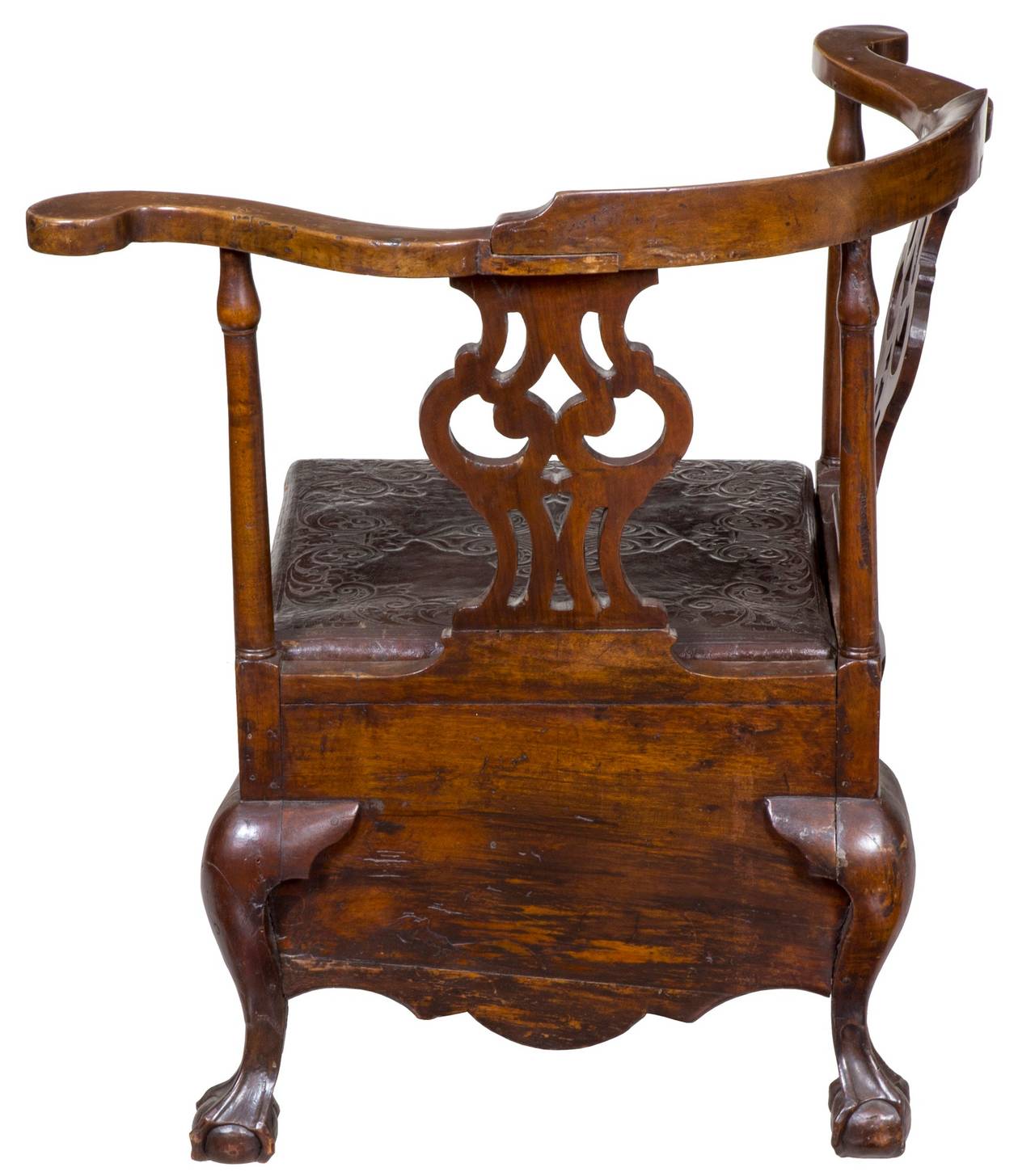 This commode stool, which would otherwise appear to be a corner chair, is quite low to be a corner chair and meant, through its deep skirt, to hold a potty insert, which is now gone. It retains its original embossed leather seat with rosehead nails,