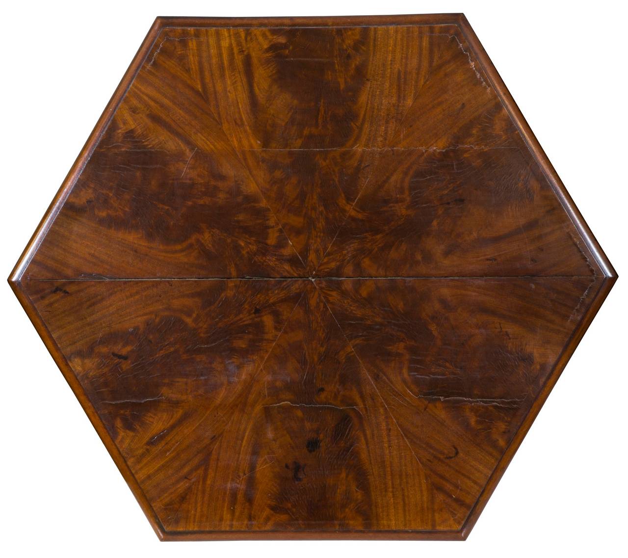 This Classic hexagonal center table uses the six-sided form to its advantage with coordinated matching figured mahogany achieving a dramatic effect (see image). Sometimes, these tables have marble tops, which lean toward a later Victorian concept