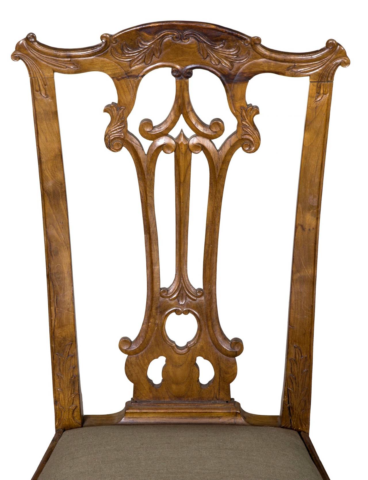 These chairs are some of the finest carved Portuguese Colonial chairs extant. Note the strongly shaped front legs, which are profusely carved at the knees with the English style C-scroll. Also note the shaped seat apron, which is further carved.