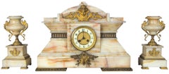 A Victorian Variegated Marble Mantel Clock with Figural Mounts, circa 1880-90