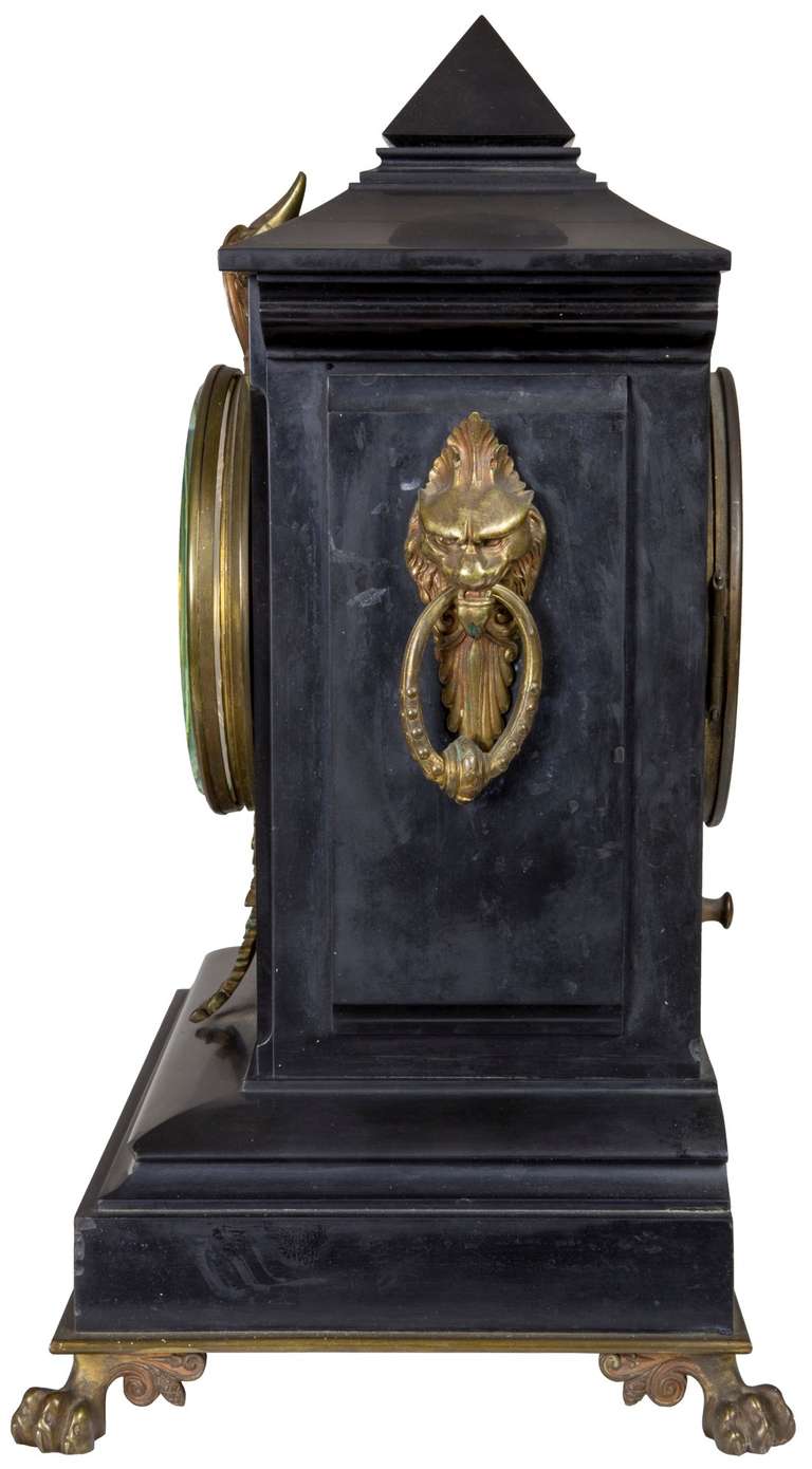 This black polished slate clock in marble has the architecture of the late Victorian period with nicely cast metal fittings throughout that have tarnished through time. Many collectors like things left untouched, so we have deliberately have not