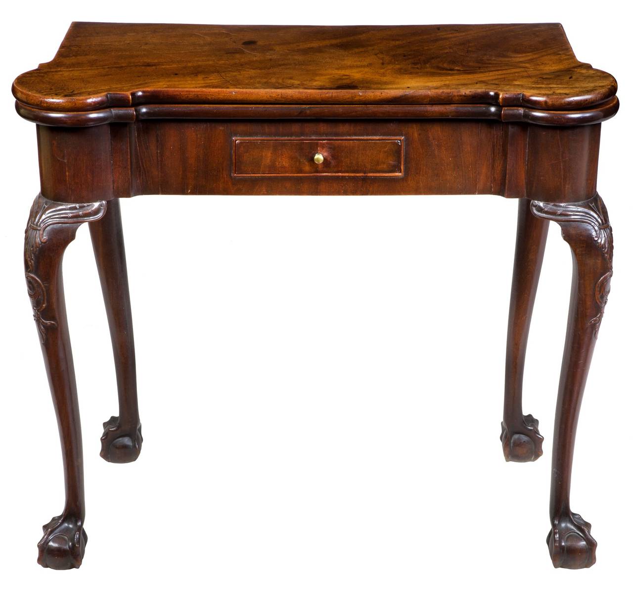 This card table has one of the most desirable of early Chippendale forms, with its beautiful turret corners, which, when open, are serviceably fitted for card games. The small drawer, which is usually replaced and rebuilt, is absolutely original and