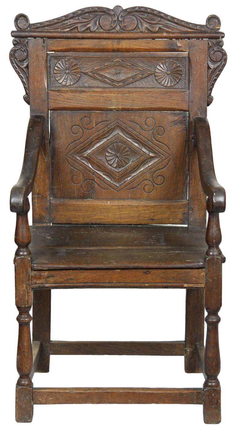 This is an early chair in superb condition. Generally, these chairs have replacements, i.e. a new arm or a pieced leg, etc. This chair has all of its parts and is the real thing, including it well-worn seat. Artistically, this is a beautiful example