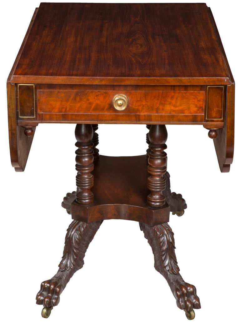 This classical form with four turned columns is typical of the later classical period. An example of such is illustrated in furniture of the olden time (see scanned image below). This table has a top of all single solid boards with clover leafed