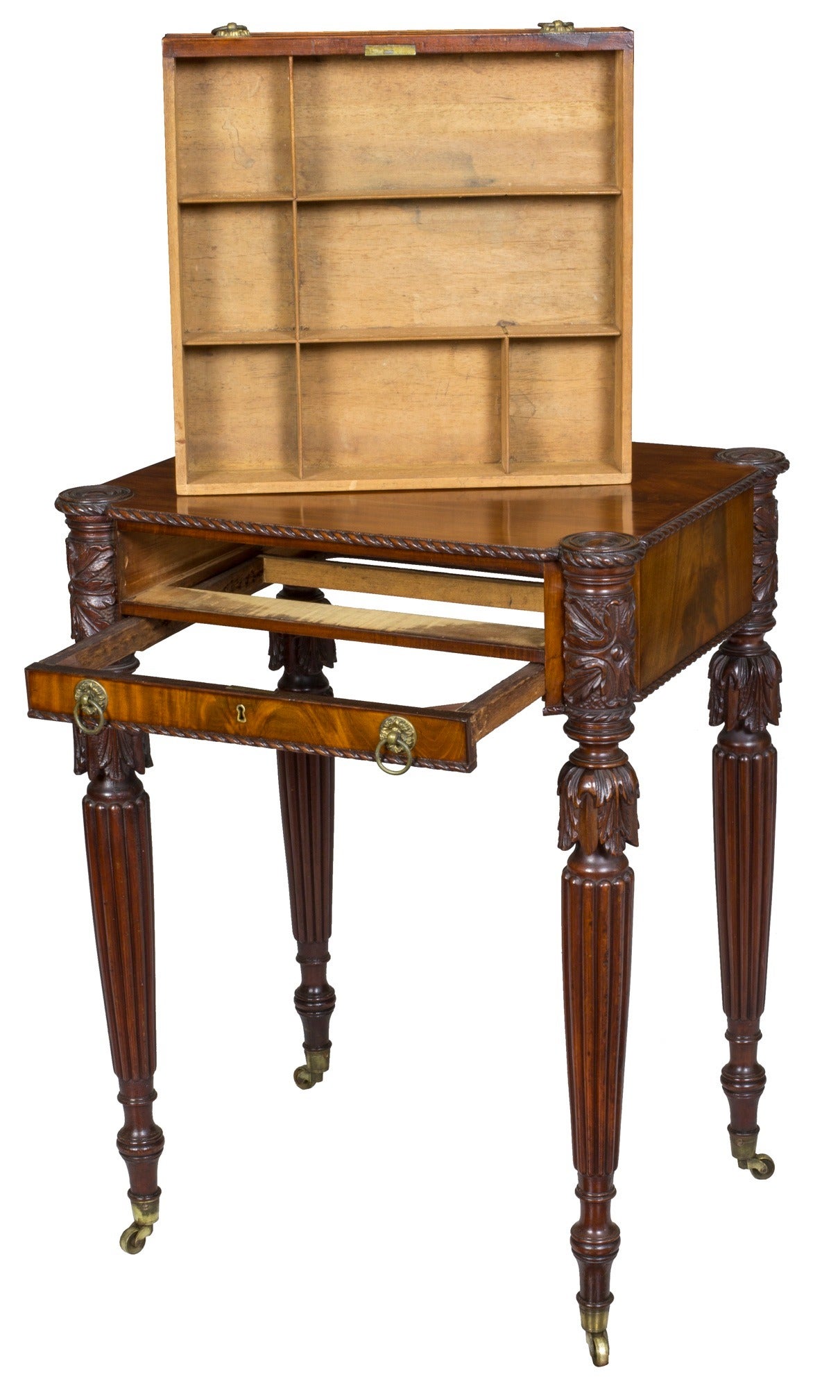 This fine, fully developed work table is composed of highly figured mahogany and presents a commanding presence with four sumptuously carved legs. The carved colonettes of leafage and punchwork above tapered reeded legs are Classic Salem, and