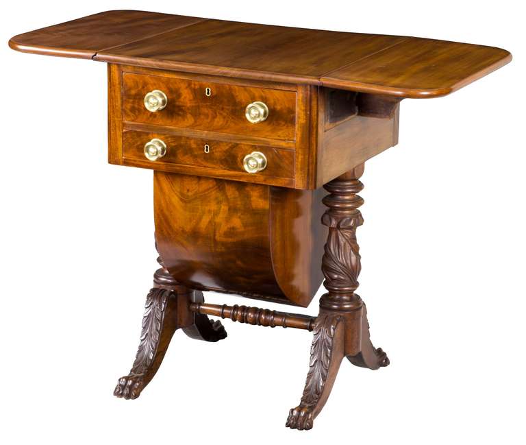 This piece is a fine example of the late classical/Empire period, complete with its original highly figured wooden basket. The top is solid mahogany as are the carved supporting columns and feet. Of note, are the fully carved acanthus legs, with