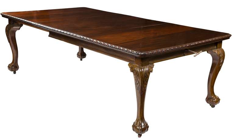 This table is composed of solid leaves of vibrantly figured mahogany which is carved with a gadrooned molding at its edge. There is one middle section that is removable and is operated by a crank mechanism, which was in fashion at the time.
