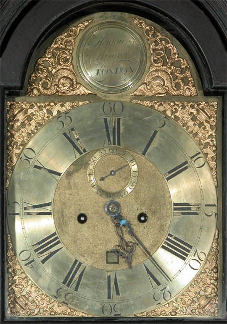 This is a good sized Queen Anne tall case clock retaining an early Japanned surface in the Chinese motif. The case was restored some time ago, and is in fine condition. The movement is an 8 day brass works by a good recognized English Clock maker.