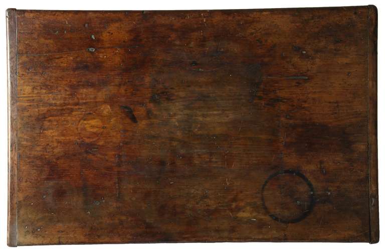 This is a traditional New England tavern table with drawer, which is completely original (see details). This table also has its original one board pine top with baton ends and only its original large nails holding it down. The legs are turned and