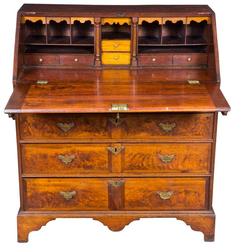 This is a small-scale Queen Anne desk on bracket feet with magnificent inlays. An example of a highboy with sectioned inlays such as this is illustrated in Levy Galleries in search of excellence. The desk has acquired a beautiful warm amber glow
