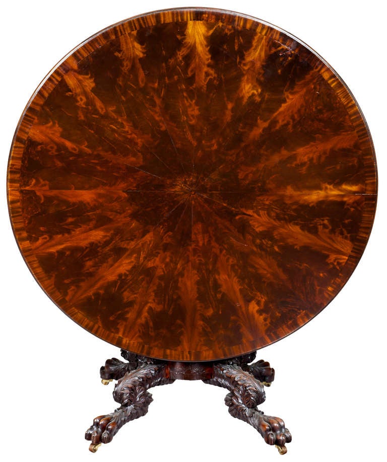 This grand center table has an elaborate 16-sectioned mahogany top which is further enhanced with a crossbanded edge (see detail). This elaborate top is stylistically reinforced with a complementary apron, again, of matched crotch grained mahogany.