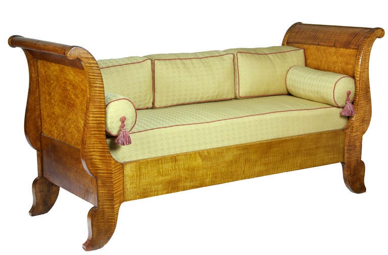 Originally, this was a much wider bed, a sleigh bed that was shrunken down to daybed size for use as a commodious sofa and/or daybed. The four supporting side members are all solid tiger mahogany of the finest color. The rails holding the two sides