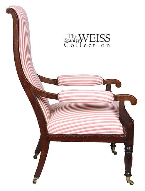 This is a Provincial example of the lolling chair form and is delicately executed throughout. Note the baluster shaped front legs and the stylized arm supports which lend a feeling of good support to the arms which terminate with small scrolls. The