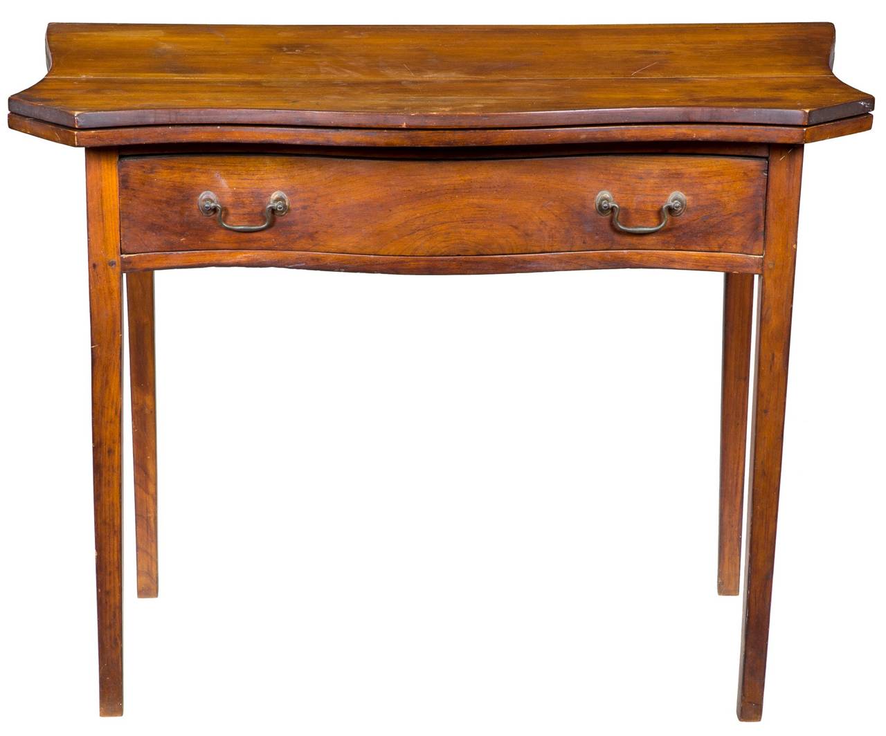 This transitional table has the typical Chippendale serpentine shaped face with a drawer whose front is composed of solid cherry that is carved from a four inch thick log (see detail). The legs, however, are Hepplewhite in style, being long and