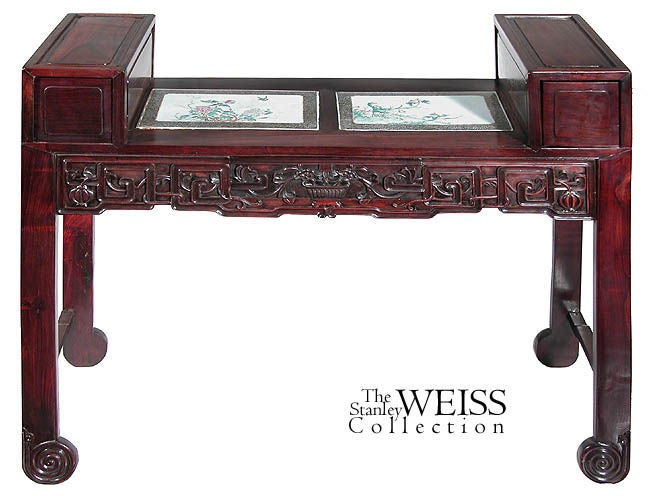This very interesting desk is finished equally on both sides and the drawers similarly open on either end (both the lower drawer on the carved apron, as well as the two upper drawers that flank the porcelain inserts). The rosewood is an Asian