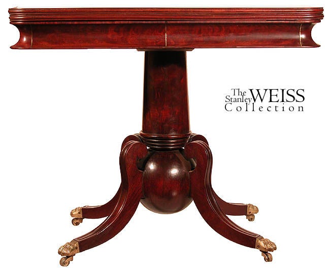 From a design point, this is an exceptional card table with rarely seen columnar base. The design statement is striking with a "cannon ball" shaped base below a tapered column that terminates in a series of rings. The saber legs are