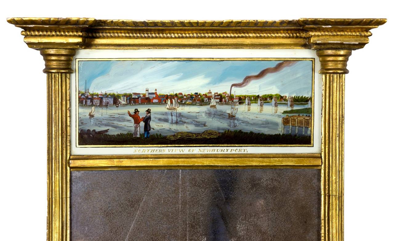 This mid-sized mirror retains its original mirrored glass, backboard, and label of the maker, Stillman Lothrop. Mirror labels are quite rare and this is preserved in its entirety (see images). The Newburyport painting appears to have its original