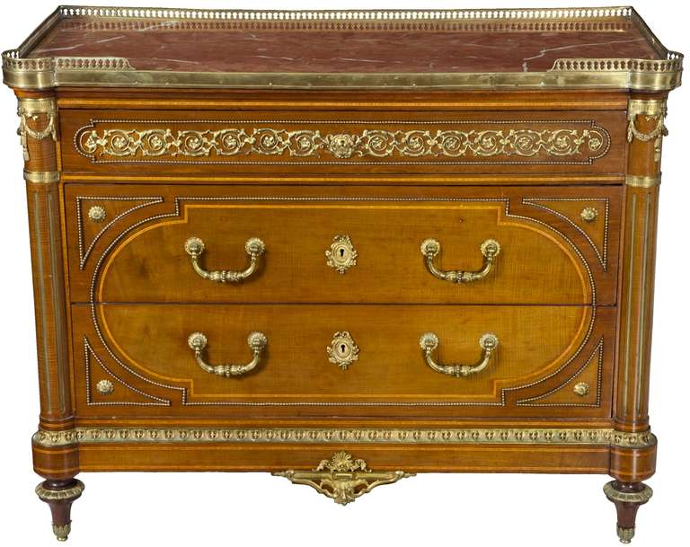 A fine English ormolu-mounted rosewood banded and mahogany marble-top commode signed by Edwards & Roberts, London, in the French taste, late 19th century. This tour de force has a shaped rouge marble-top with a brass reticulated three-quarter
