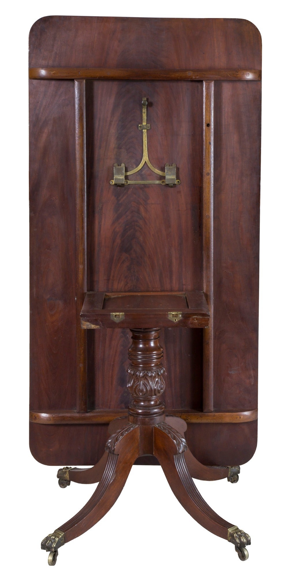 We have a number of breakfast tables that tilt up and all retain a similar pull up catch; however, this is the first of a New York Phyfe style we have seen. The urn is beautifully carved, as is the acanthus at the knee of each leg followed by