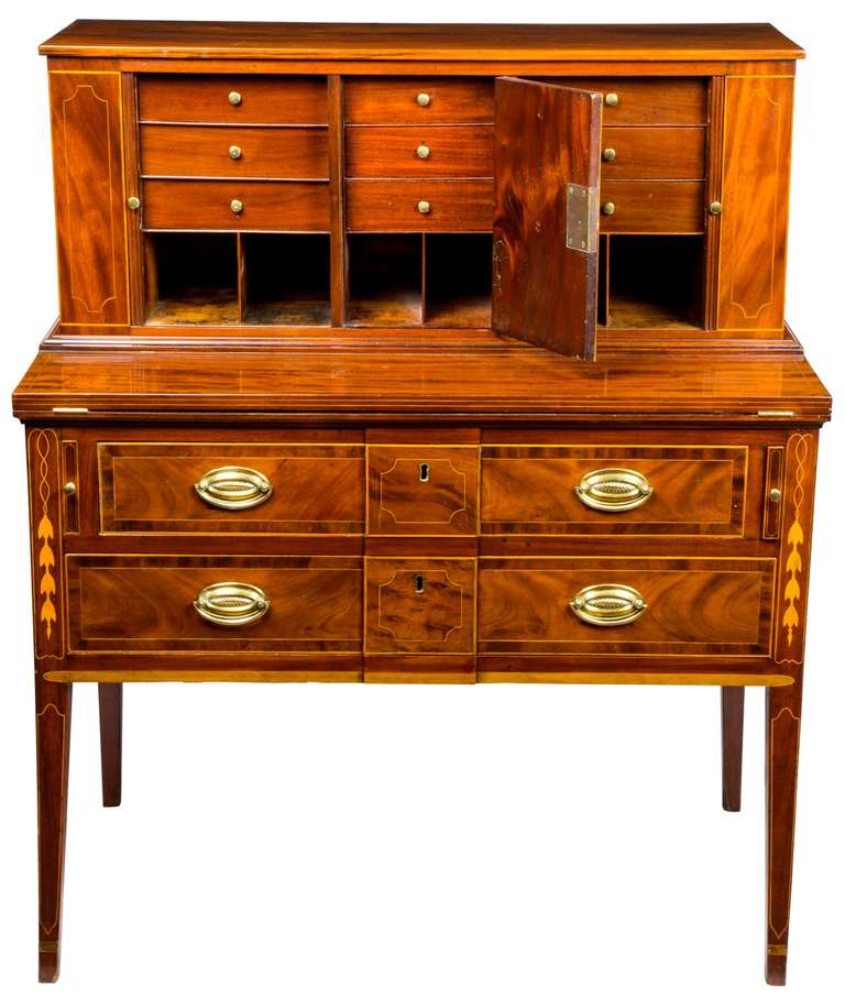This is a beautiful inlaid tambour desk with a striking drawer design featuring a prominent central panel.
 
This desk is a period desk that has had restoration to its internal structure, but visually, it is complete.   There are historic