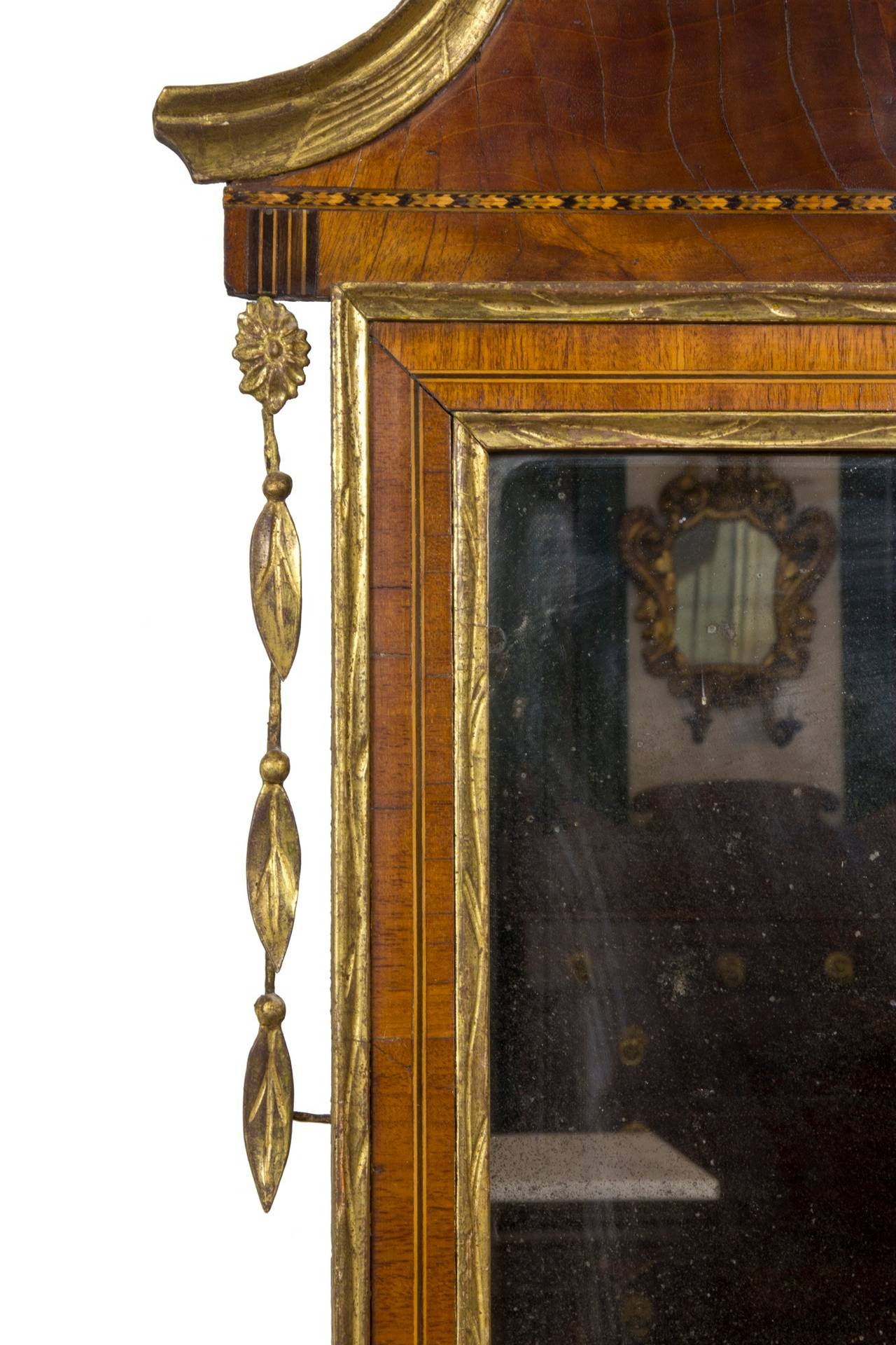 This mirror, retaining its early glass, is in a fine state of preservation and is complete in all its parts. These mirrors are very delicate and often lose their embellishments. The surface is old and has a rich, warm feel. The gold leafing is all