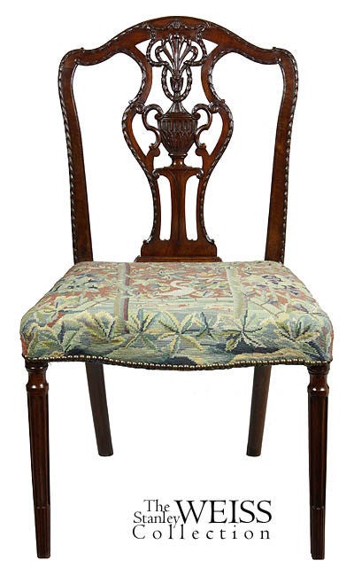 While only a single chair, this is a beautifully crafted chair in the finest Sheraton tradition. Note the magnificent carving on the crest, splat and chair stiles. Also, note the bowed front seat and the stop-fluted legs. It is upholstered in an old