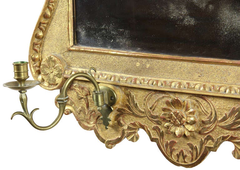 This is one of the great gilt mirrors and is in superb original condition, including the candleholders, beveled glass, backboard, etc. Without being overly large, this mirror is a standout in any room. The gold is beautifully preserved and the