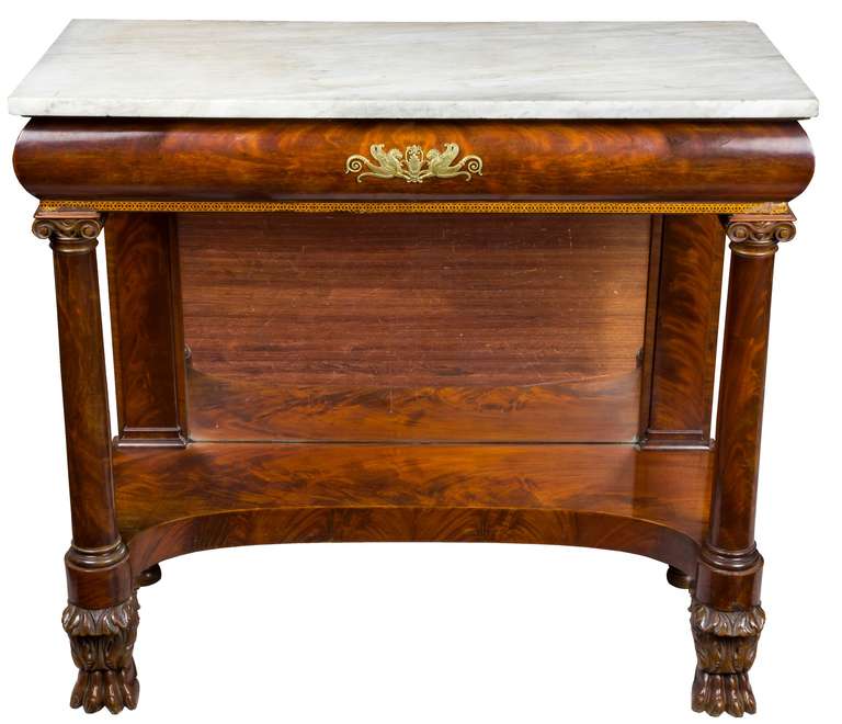 This small-scale marble-top table is in fine condition with excellent color. This pier table has strongly carved paw feet as well as well pronounced scroll capitals above each of the columns. The mount is sensitively executed and not overpowering to