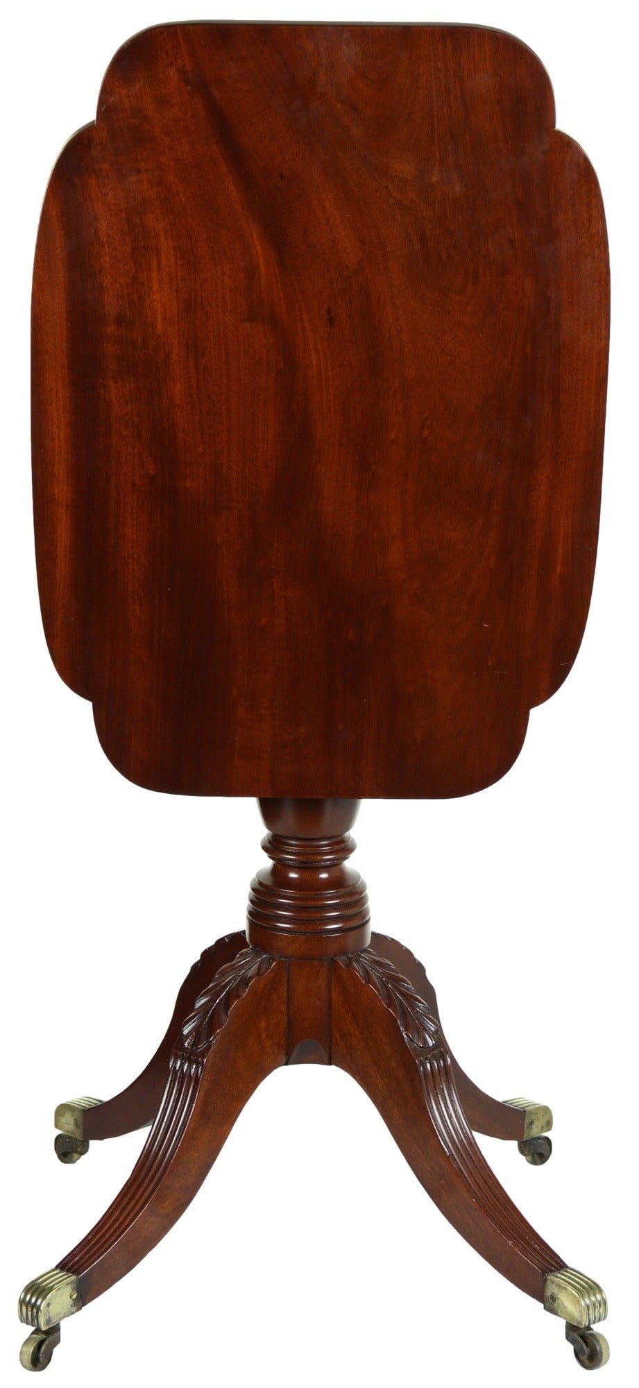 This is a very rare small tilt-top table with four legs. Usually, these have three and four legs really make a difference in that it feels very solid to the ground. The wood is beautifully figured, and the craftsmanship top drawer. Note the reeding