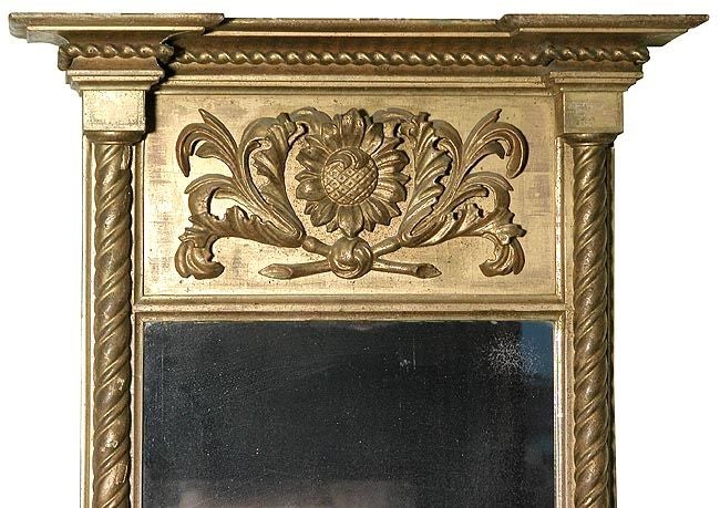 This mirror retains its original glass and backboard, the gilding is original and the carved panel is quite uncommon. It is in excellent condition and of good size.