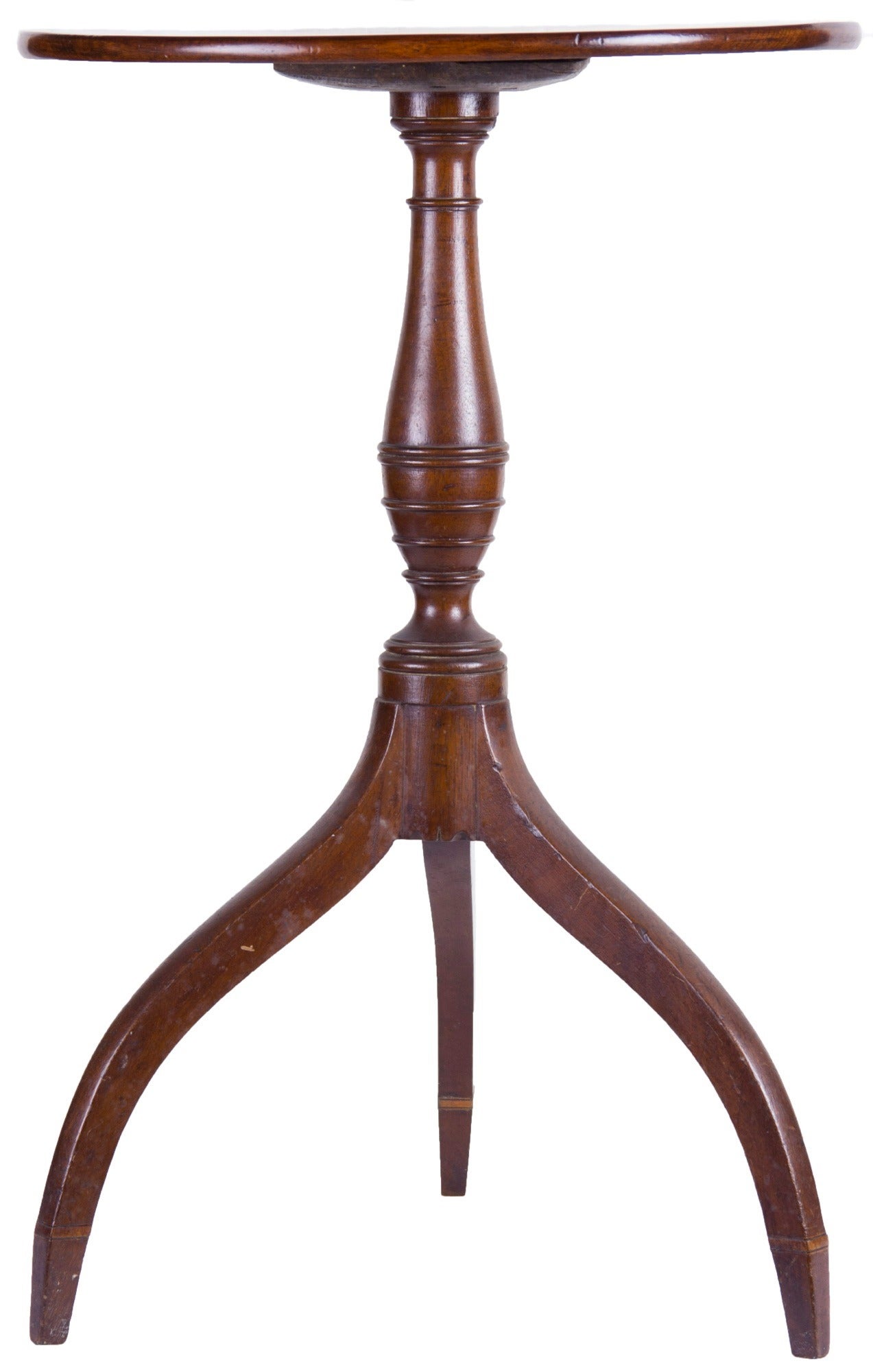 This is a lovely candlestand with great style. Note the very high lift of the legs, almost exaggerated, but beautifully formed to receive a baluster column with horizontal reeding similar to documented Seymour pieces.

The top is of a fine