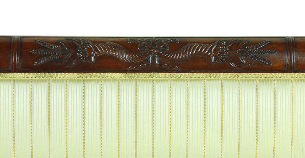 This sofa has a beautifully carved crest rail with a deep, dry old surface that has been left alone for many years. The carving is quintessential Phyfe, and the shape of the crest rail, which strongly arches back, is a key trait. This type of Curule