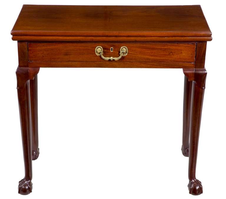 For a small card table, this has the most desirable features for the form. Unlike most card tables, this table boasts a drawer as well as claw and ball feet. Also note the lamb’s tongue carved elements below the table’s skirt, another feature not