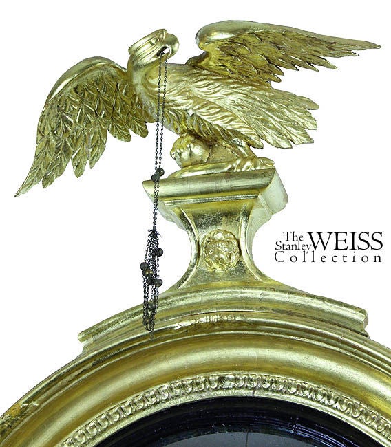 This striking girandole is completely original with a strikingly well-carved dynamic eagle holding a chain, all of which is supported by deeply carved acanthus centering a dish with Classical lion’s head.

Please view the various details below, in