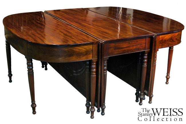This table of extraordinary width uses double hung leaves to its fullest length to create its size. The heavy leaves are all of dense solid grain Santo Domingo mahogany; the ribbon grain vividly contrasts each leaf. Each leaf and top is of one