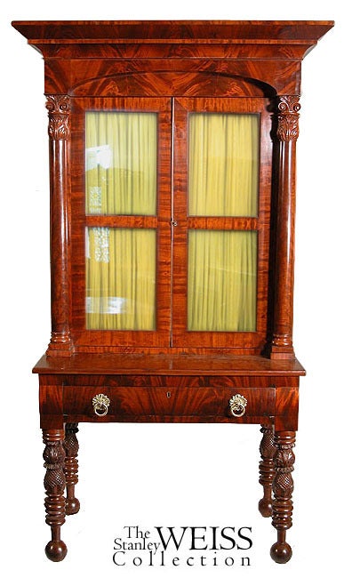 This monumental desk or bookcase is composed of solid mahogany with highly figured mahogany veneers that have retained a vibrant visual glow. It is in superb condition with no alterations or repairs. The legs are robustly turned and embellished with