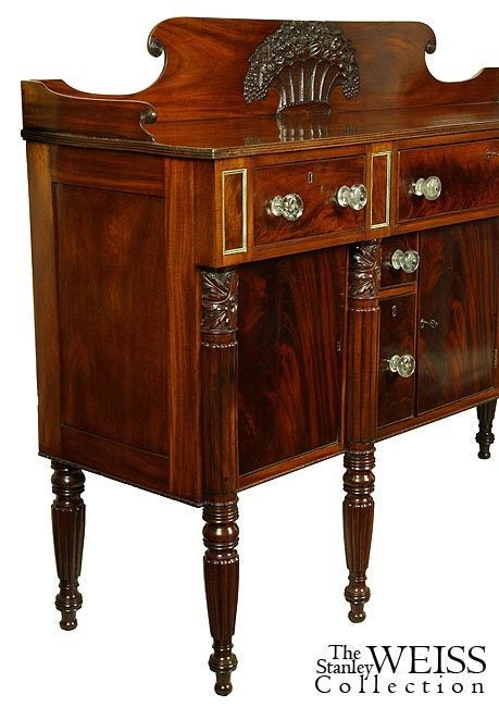 This is one of the most developed Salem sideboards with an amazing basket of fruit (see detailed images below), the likes of which are extremely rare. The case has brass-embellished panels above strong, well-carved columns, with quintessential Salem