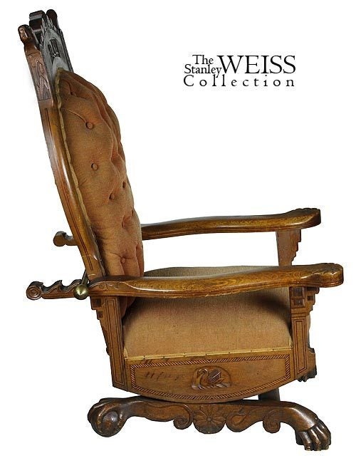 This masterful yet whimsical chair exhibits fine carving on all surfaces with animals, and art nouveau wheat carving oppsite the crest rail.  The oak is very smooth and is embellished with varying inlay work of alternating contrasting woods, not