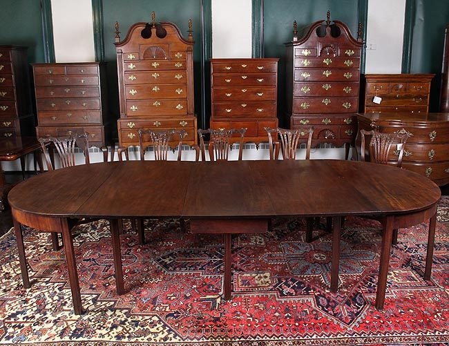 Colonial banquet tables are rare and the table above relies on classic Chippendale square molded legs. The three sections of this banquet table are united by a large mahogany board top, and complementary figured mahogany veneered apron. This table