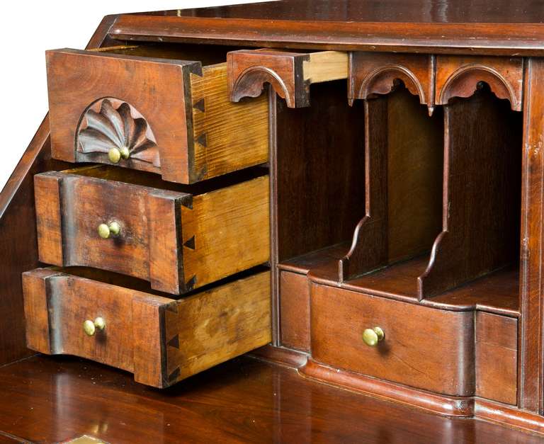 Composed of beautifully figured dark, dense Cuban mahogany, this is what the famous Newport desks are known for. Some hallmarks of the Newport tradition are the shaped arch-work above the small pencil drawers above the valances in the interior and