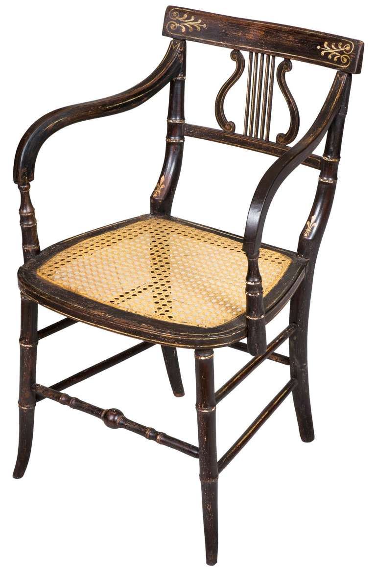It is rare to find a set of six chairs with Lyre backs in their original rosewood grain paint and decoration. These chairs are early in the period, of small scale and are in fine original condition. Of note is that this set retains its original two