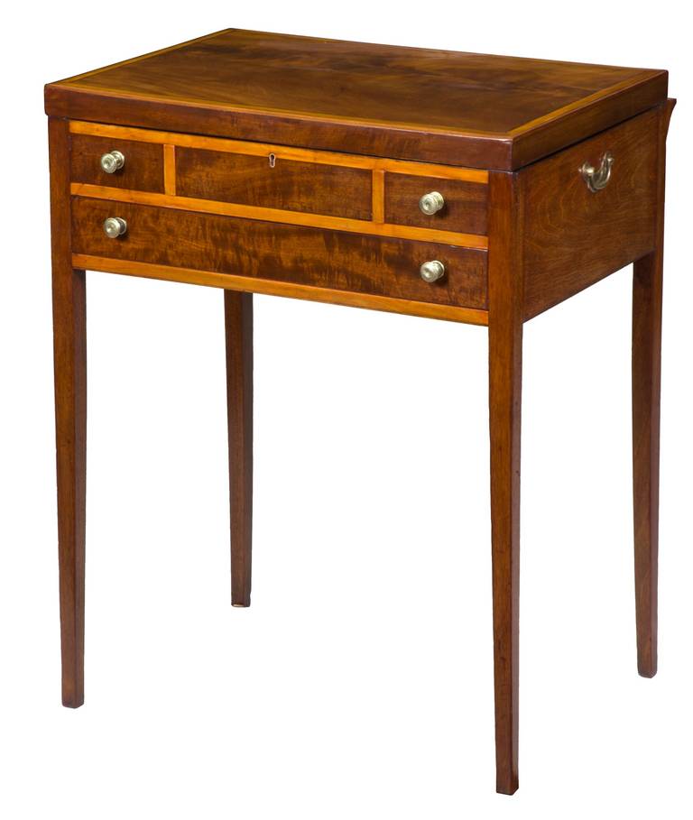 This Beau Brummel is in superb condition, with its original pulls and side handles. The top (see image below) is composed of a magnificent piece of figured mahogany that has aged through the years to a warm, amber tone. All of the components of the