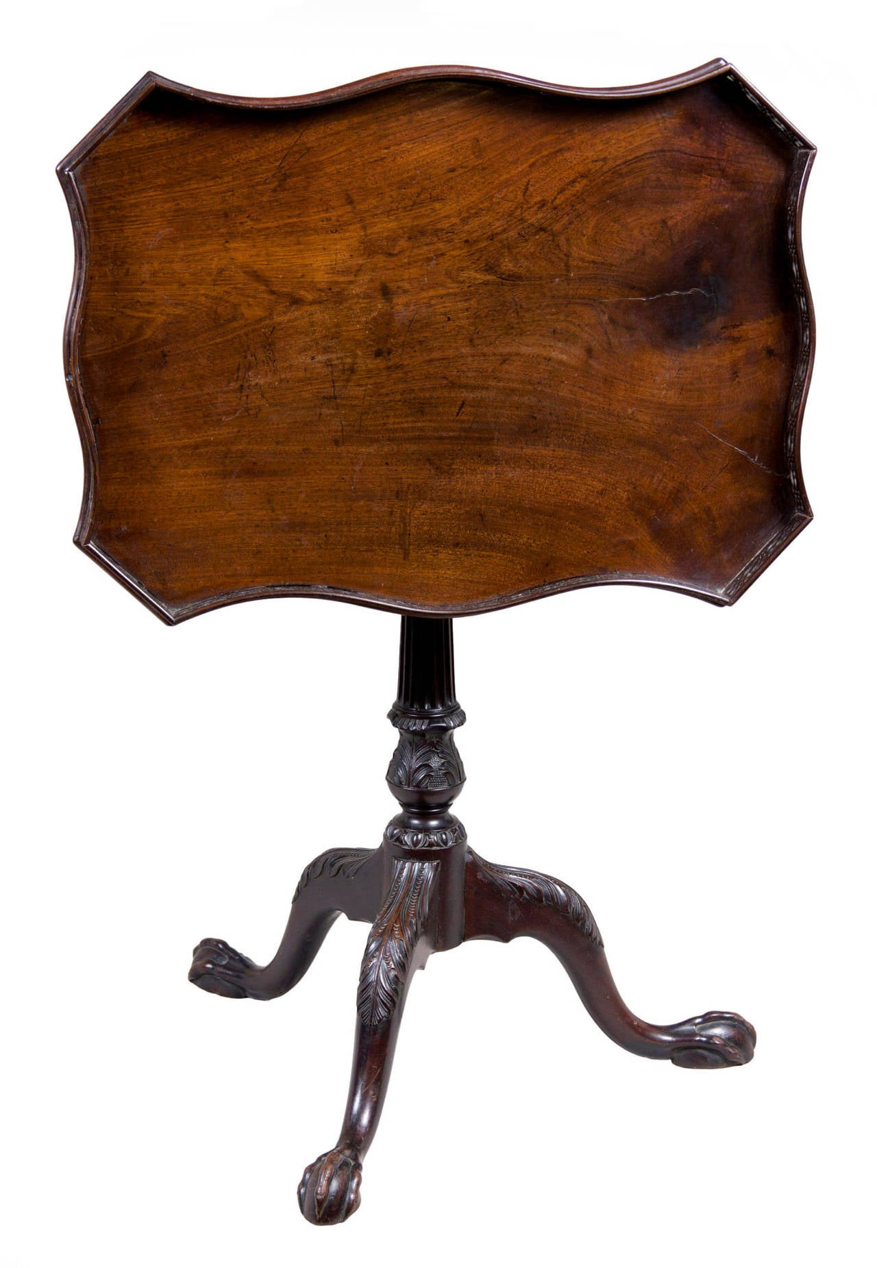 These tilt-top tables with pierced galleries are often called silver tables, as this would accommodate a tea service with a protective edge. The top is composed of a beautiful piece of mahogany with a wonderful patina with age shrinkage and a