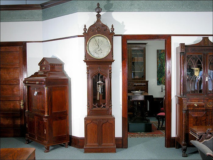 This monumental regulator stands over 9 ½ ft. tall and was deaccessioned from the Fraunces Tavern Museum. For an image of this clock in relation to other furniture, see image #2. This regulator retains all its original parts including finials,