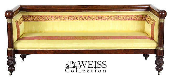 This is one of the finest of the box sofa forms, with finely detailed ormolu mounts, at the ends of each sofa column. This sofa makes a very strong statement, and the beautifully carved acanthus feet above reeded melon bulbs on castors.

The