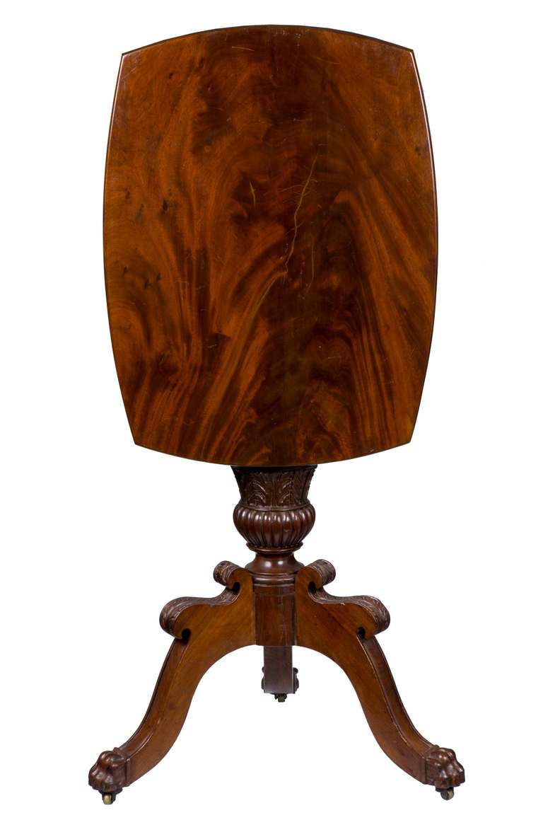 While tilt-top tables were a popular Colonial and Federal form, at this time, it was clearly less popular, as few neoclassical examples are found. This table has a highly figured solid mahogany top which is chamfered underneath, giving a more