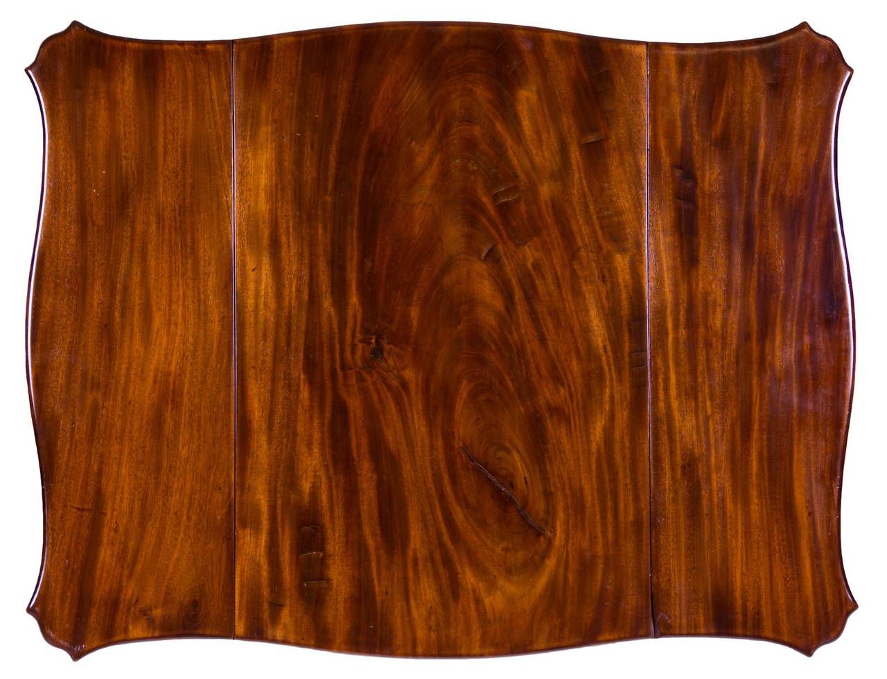 This piece is composed of the most vibrant figured mahogany. The leaves are beautifully shaped in a serpentine form with canted edges. There are no joined boards; all is of the solid. 

This piece is attributed to John Shaw and there are several