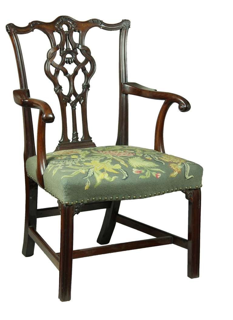 This is a highly developed Chippendale armchair of the finest quality. Note the crest rail with the floral edge carving and the beautiful carving where the crest rail meets the side stiles. The splat is quite detailed and well-thought out with