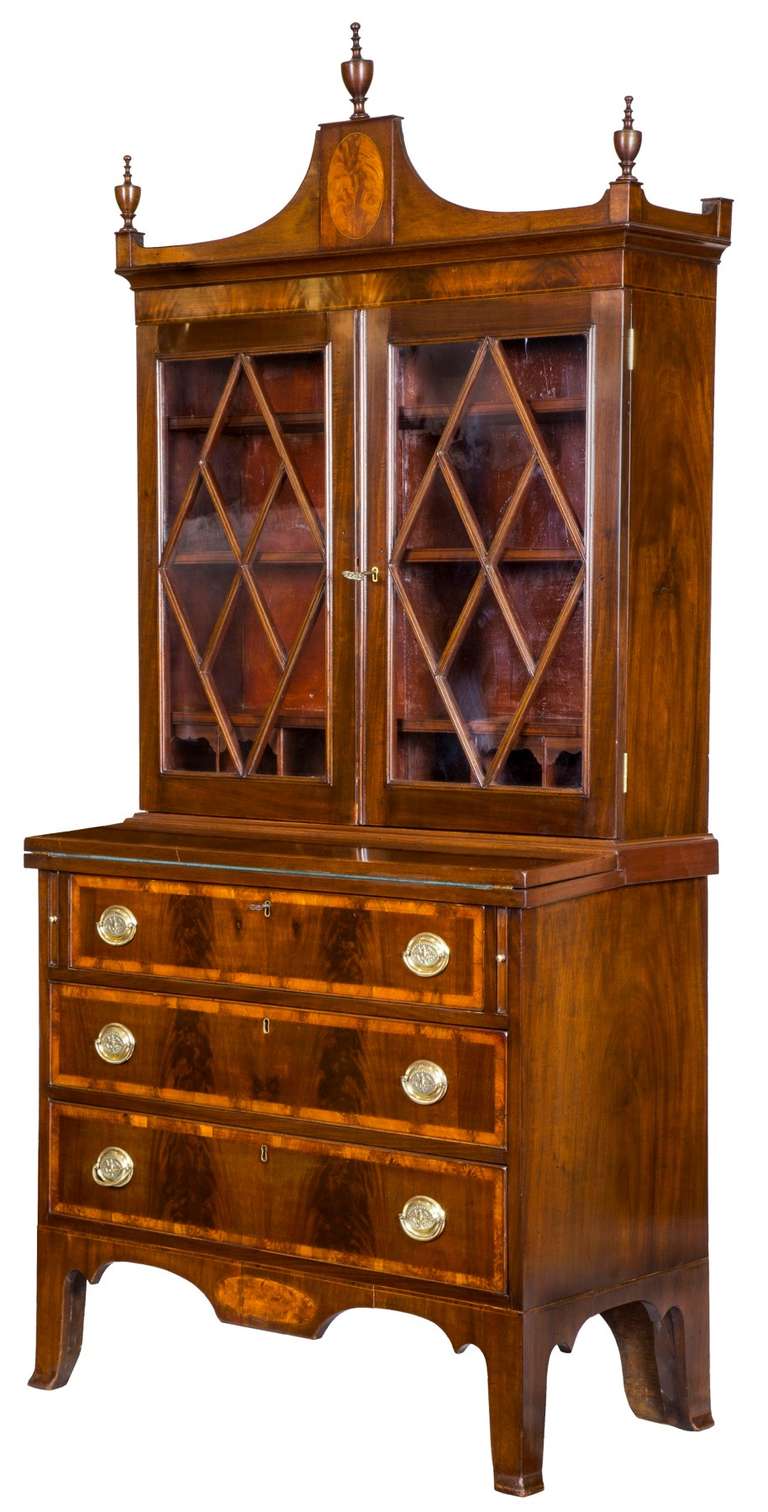 This secretary is of small scale, almost diminutive, at 36 inches wide.  It is a real treasure that has all the bells and whistles.  It has a beautiful inlaid oval in the rather tall pediment and bears its original finals, which are almost always