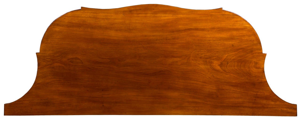 This piece is a sideboard without sides as the shape of the case is defined by undulating curves with conforming doors that diminish in depth along the wall, making its serviceability a great asset. As it is rather deep, relative to size, it can